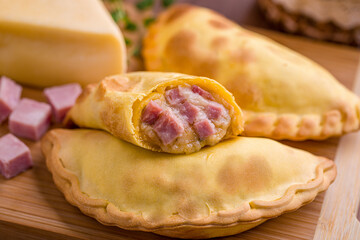 Delicious Ham and Cheese Empanadas on Wooden Board