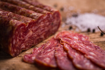 Close-Up of Sliced Salami On Rustic Wooden Background