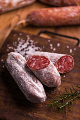 Delicious Sliced Italian Salami on Wooden Cutting Board with Spices
