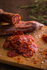 Rustic Sliced Salami On Wooden Cutting Board With Spices