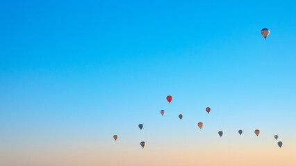 Hot air balloons fly in Cappadocia on an autumn morning.