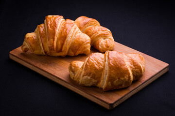 Freshly Baked Croissants on Wooden Cutting Board
