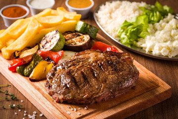 Tasty Grilled Steak with Vegetables and Golden French Fries