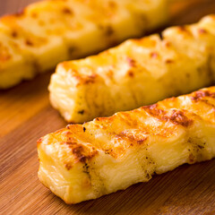 Grilled Coalho Cheese Sticks on Wooden Cutting Board