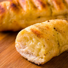 Close-Up of Grilled Cheesy Garlic Bread on Wooden Board