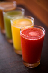 Colorful Array of Fresh Fruit Juices in Glasses on Display