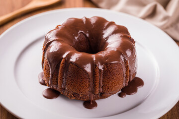 Delicious Chocolate Bundt Cake With Rich Glaze on White Plate