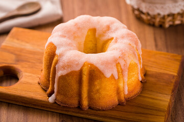Delicious Bundt Cake With Icing On A Wooden Serving Board