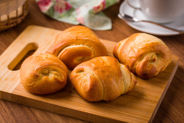 Freshly Baked Rolls on Wooden Cutting Board for Breakfast