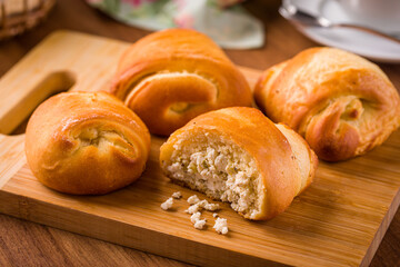 Freshly Baked Cheese Rolls on a Wooden Cutting Board