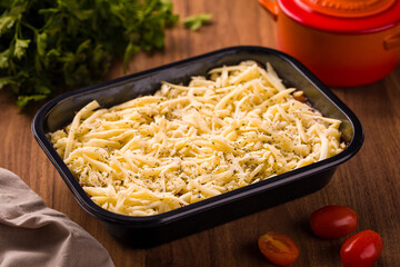 Delicious Cheese-Topped Baked Dish on Wooden Table Setting