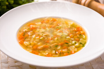 Warm Vegetable Soup in White Bowl with Steam Rising