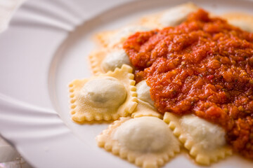 Delicious Homemade Ravioli with Tomato Sauce on White Plate