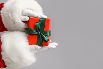 Santa Claus with red gift box on white background