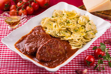 Delicious Italian Pasta and Meat Dish with Fresh Tomatoes and Herbs