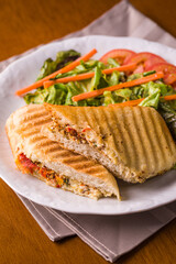 Delicious Grilled Panini Sandwich with Fresh Salad on Plate