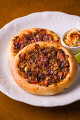 Delicious Mini Pizzas With Vegetables And Hummus On White Plate