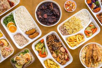 Assorted Takeout Meals in Bento Boxes on Wooden Table