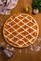 Delicious Homemade Chicken Pizza on Wooden Table with Fresh Ingredients