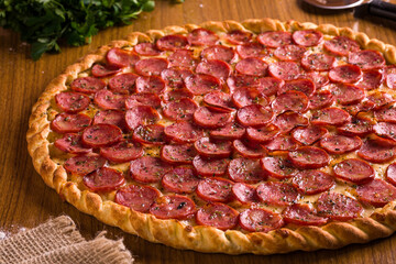 Delicious Calabresa Pizza With Golden Crust On Wooden Table