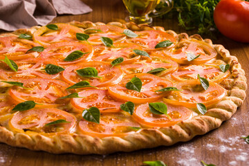 Freshly Baked Tomato Pizza with Basil and Olive Oil Garnish