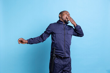 African american security guard feeling exhausted in front of camera, working on safeguarding a...