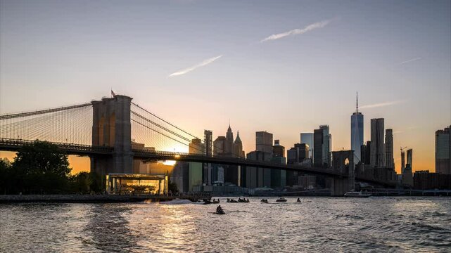 New York City - USA - Sep 11 2024: Day to night time lapse of tribute in light 911 memorial over Lower Manhattan skyline and Brooklyn Bridge