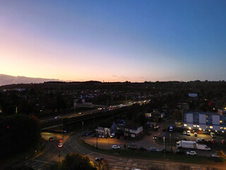 Fototapeta premium Aerial View of Illuminated Luton City of England UK at Just After Sunset and Full Moon Night. Aerial Footage Was Captured with Drone's Camera on October 17th, 2024