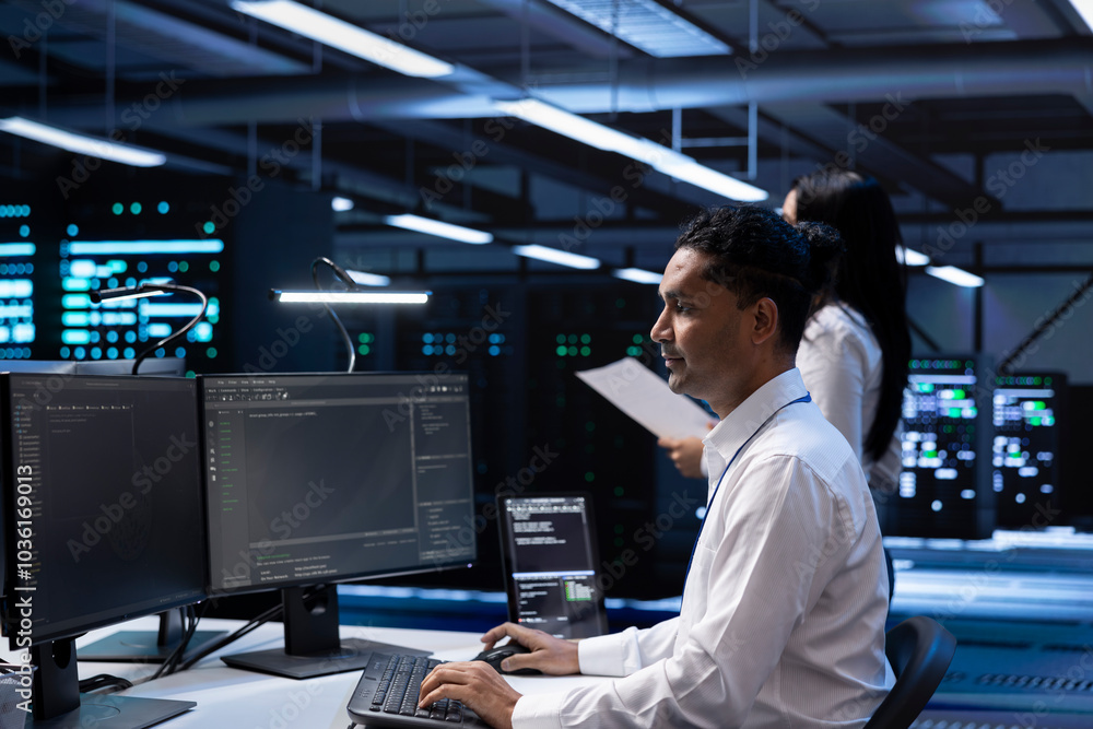 Poster system administrator in data center checking equipment performance on computer after upgrading hardw