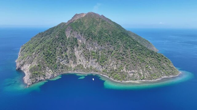 The scenic island of Komba lies about 70 km north of the island of Lembata in the Lesser Sunda Islands of Indonesia. This remote island, surrounded by reef, is an active volcano that often erupts.