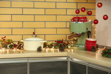 Coffee machine with dishes and Christmas decor on counter in kitchen