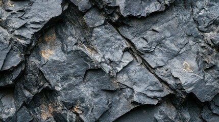 A close-up view of textured dark slate rock surface with natural patterns.