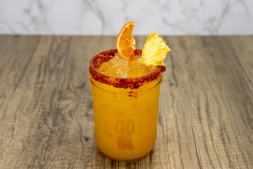 Sweet tasting Margarita served in glass and topped with lemon and orange