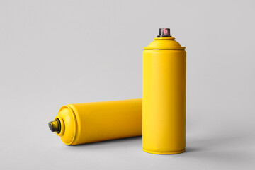 Spray paint cans on white background
