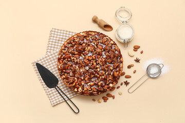 Sweet tart with different nuts and ingredients on beige background