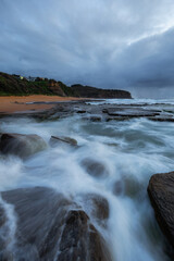 High tide water flowing into the rocky shore.