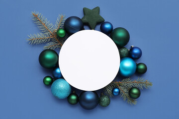 Blank card, Christmas balls and fir branches on blue background