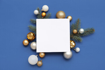 Blank card, Christmas balls and fir branches on blue background