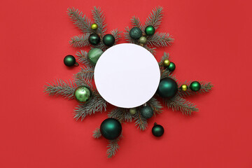 Blank card, Christmas balls and fir branches on red background