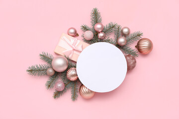Blank card, Christmas balls, gift box and fir branches on pink background