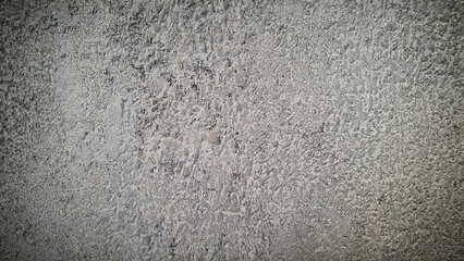 Textured stone wall background with natural gray and white tones, featuring a rough concrete-like surface. Ideal for industrial design, website backdrops, and creative projects