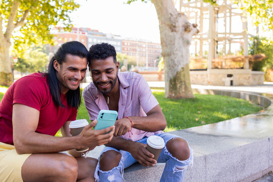 Gay couple enjoying a sunny day in city park - Powered by Adobe