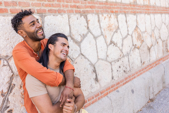 Gay couple enjoying a playful moment in the city