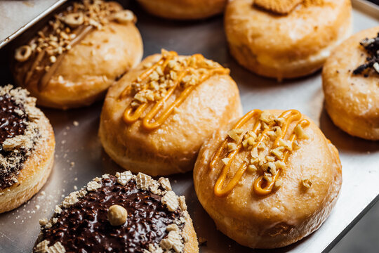 Assortment of gourmet vegan cream donuts on display
