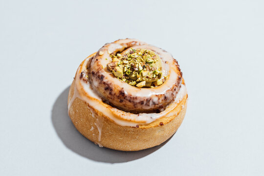 Vegan pistachio cinnamon roll on a simple background