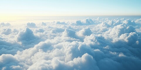 Naklejka premium Aerial view of a vast expanse of fluffy white clouds against a blue sky with sunlight streaming through.