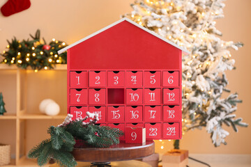 Advent calendar with Christmas branches on table in living room