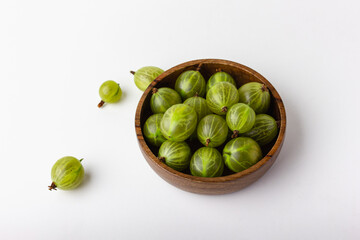 Fresh green gooseberry berries on a white background
