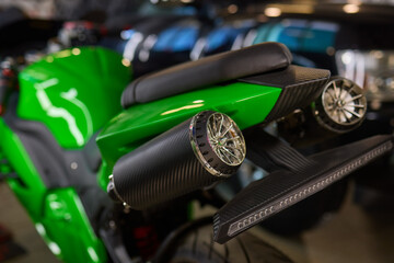 A closeup of a high performance green motorcycle showcasing exceptional design and innovation