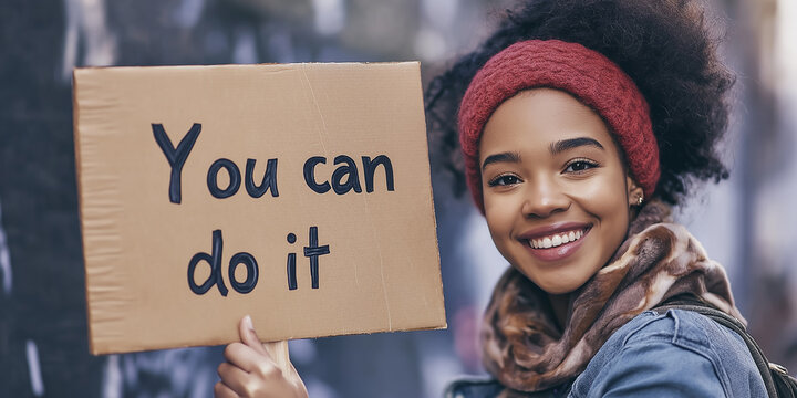 Young woman smiling and holding you can do it sign - Powered by Adobe